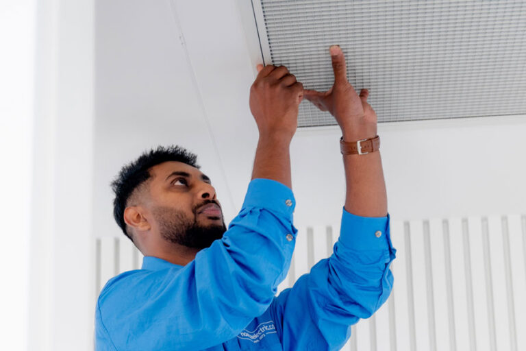 Electrician installing an AC duct